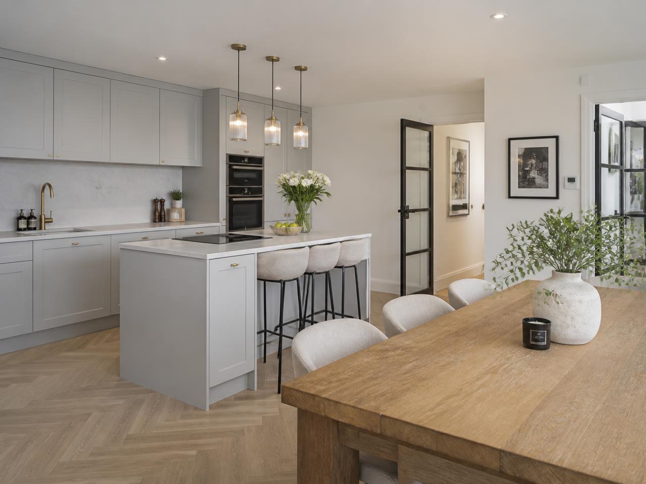 Modern apartment kitchen and dining area prepared for guest stays